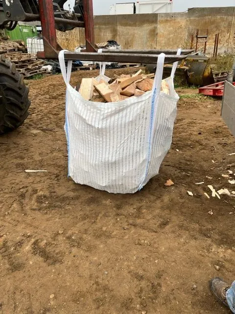 A single bulk bag filled with split hardwood logs