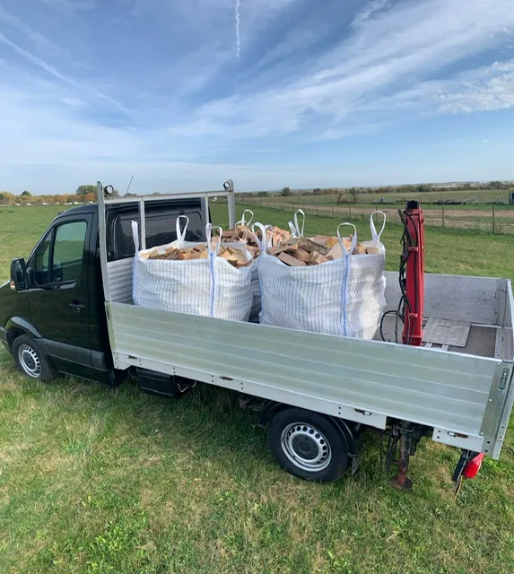 Bulk bags of logs loaded on a Logs Unlimited truck